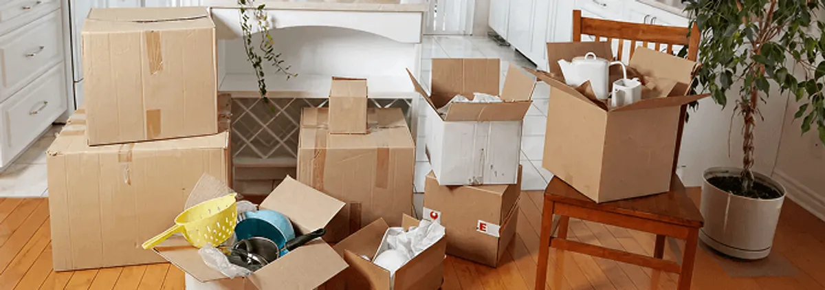 Packed moving boxes and household items in a kitchen before move-out or move-in cleaning, Columbia, MO.